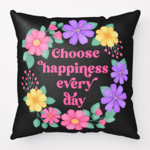 Motivational pillow with quote: Choose happiness every day. Text with purple, pink and yellow floral wreath with green leaves and foliage on black background.