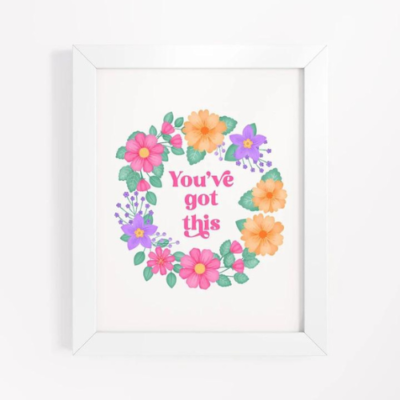 Motivational wall art with pink, orange and purple floral wreath on white background with text: You've got this.