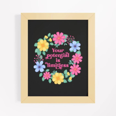 Motivational wall art with yellow, pink and blue floral wreath on black background with text: Your potential is limitless.