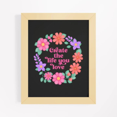 Motivational wall art with purple, orange and pink floral wreath on black background with text: Create the life you love.