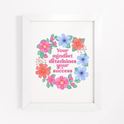 Motivational wall art with pink, orange and blue floral wreath on white background with text: Your mindset determines your success.