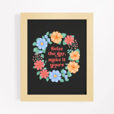 Motivational wall art with orange and blue floral wreath on black background with text: Seize the day make it yours.