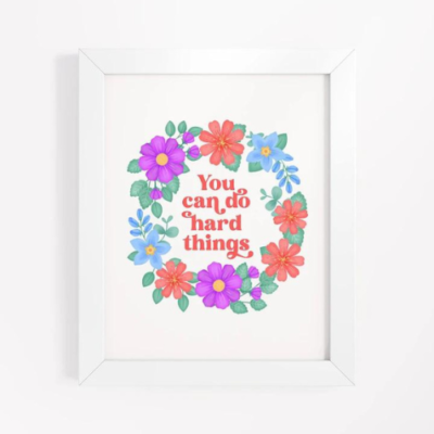 Motivational wall art with blue, orange and violet floral wreath on white background with text: You can do hard things.