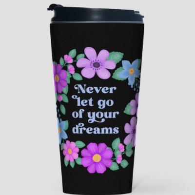 Black motivational travel mug with quote: Never let go of your dreams. Dusty blue text with flowers and foliage.