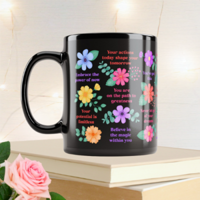 Inspirational black mug with motivational quotes and vibrant flowers.