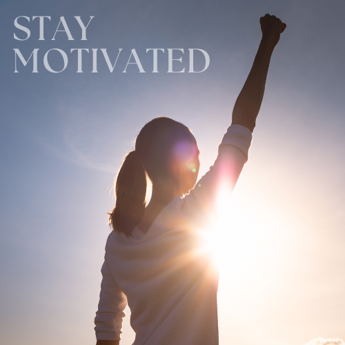 A motivated woman holding her hand up in the sunlight.